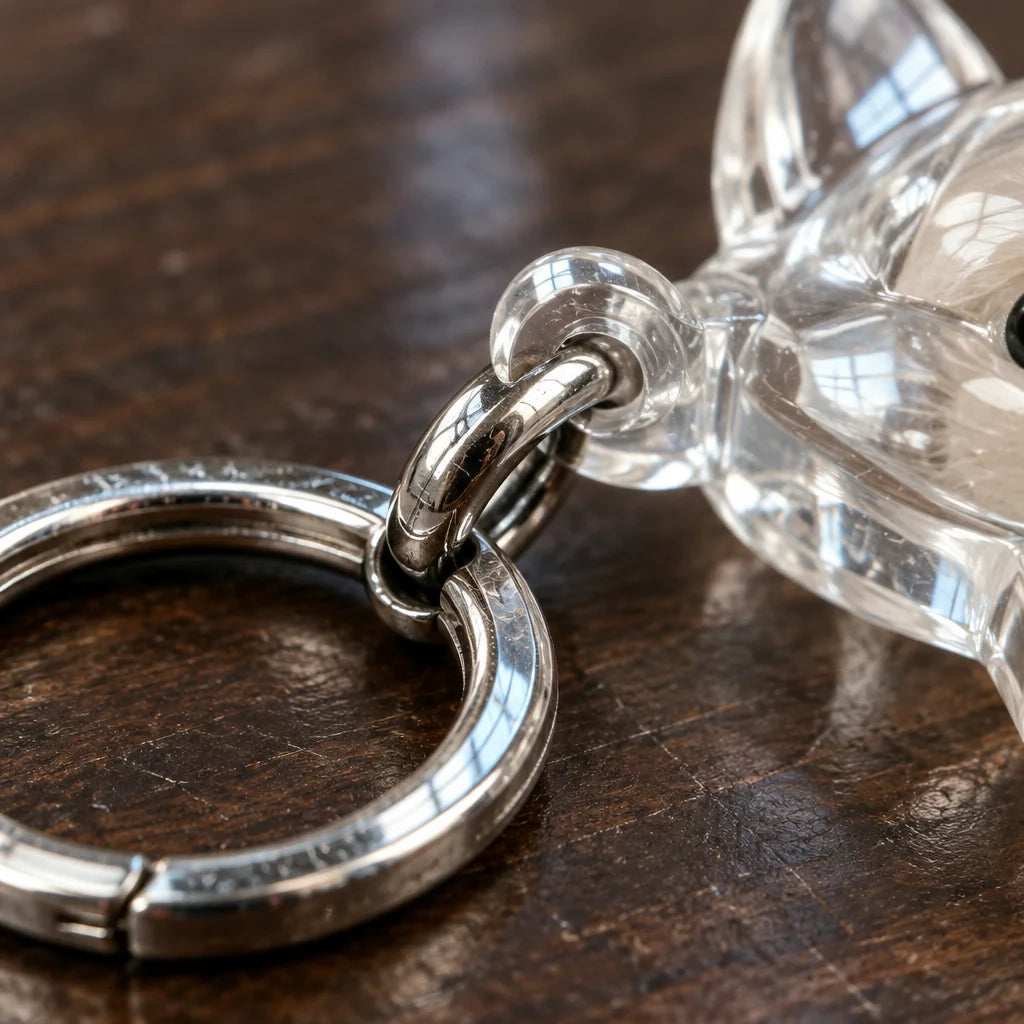 An extreme macro photograph of the silver-tone iron-alloy key ring and short connector attached to t